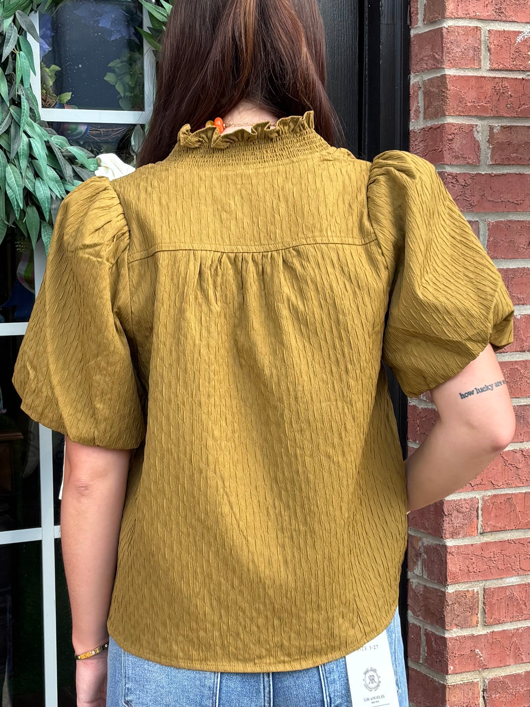 Olive Ruffled Blouse with puffed sleeves and textured finish; available in sizes XS–XL.