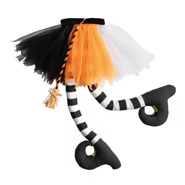 The Crashing Witches Legs is a Halloween decoration with a black, orange, and white tutu skirt, striped black-and-white legs, and curled shoes with gold buckles. Available sizes: 25″ and 32″.