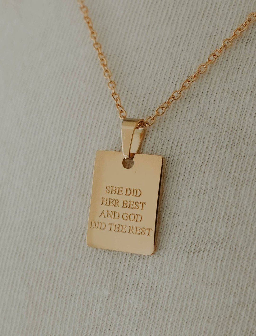 Gold rectangular pendant engraved with "SHE DID HER BEST AND GOD DID THE REST." Available in multiple sizes.
