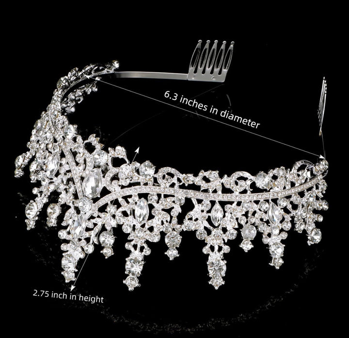 Silver tiara with clear crystals, floral and teardrop details. Size: 6.3" diameter, 2.75" tall.