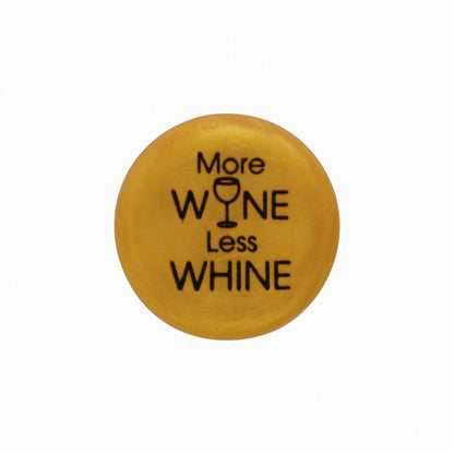 Round yellow button, "More WINE Less WHINE" text, wine glass icon as "I." Available in multiple sizes.