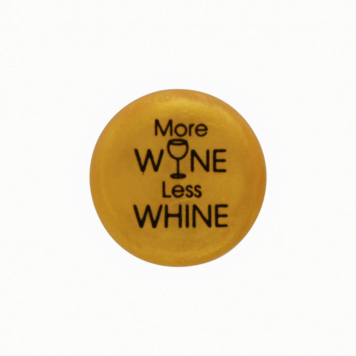 Round yellow button, "More WINE Less WHINE" text, wine glass icon as "I." Available in multiple sizes.