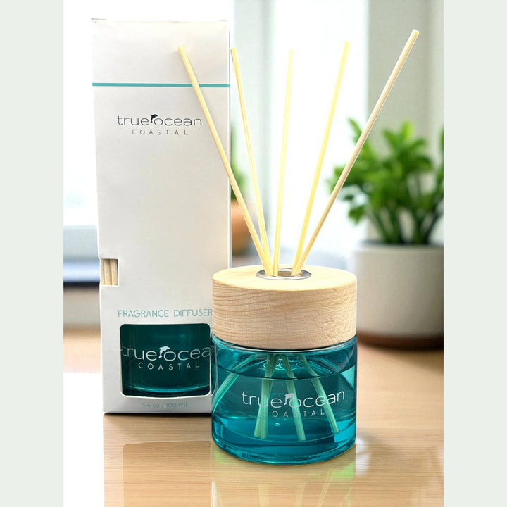 The True Ocean Reed Diffuser with blue liquid, wooden cap, and reed sticks. Available in 100ml, 200ml, and 300ml sizes.