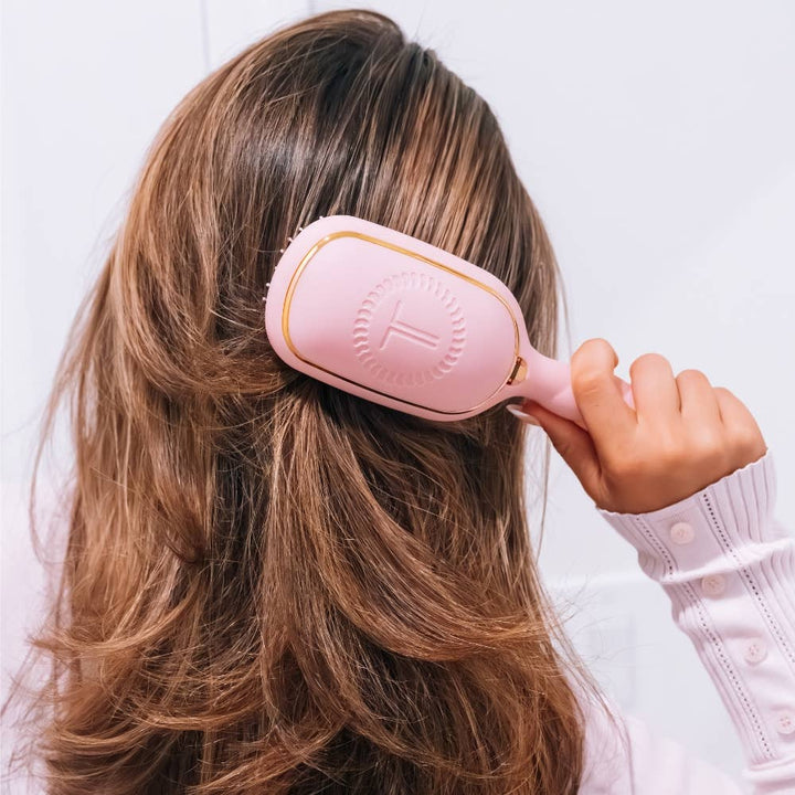 Medium Detangler Brush in bubblegum pink with gold trim for pain-free styling; available in medium.