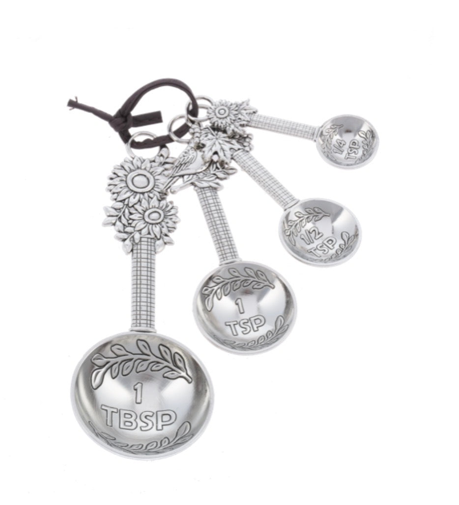Sunflower Measuring Spoon Set with four sunflower-shaped spoons on a ring, in 1 tablespoon, 1 teaspoon, 1/2 teaspoon, and 1/4 teaspoon sizes.