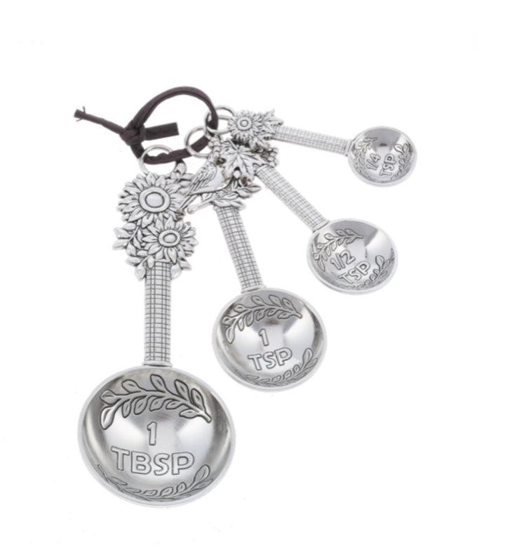 Sunflower Measuring Spoon Set with four sunflower-shaped spoons on a ring, in 1 tablespoon, 1 teaspoon, 1/2 teaspoon, and 1/4 teaspoon sizes.