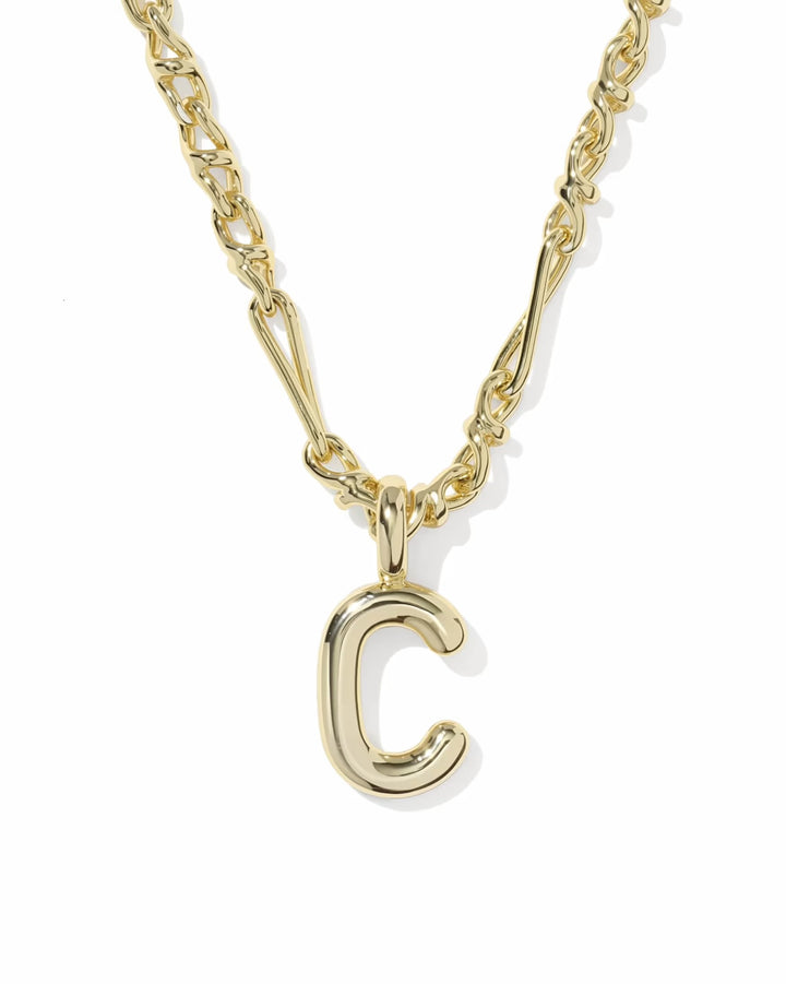 Bubble Letter Necklace by Kendra Scott with a chunky gold chain and large shiny "C"-shaped pendant. Available in multiple sizes.