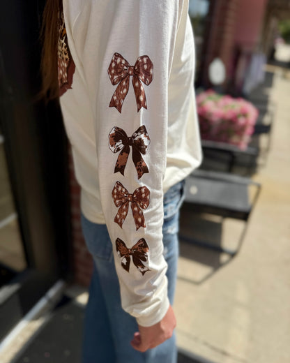 Texas Animal Print Long Sleeve with four brown patterned bows down the sleeve. Available in sizes S-XXL.