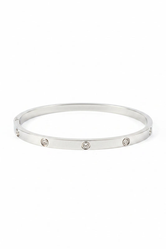 Sleek silver bangle with evenly spaced round gemstones, ideal for stacking. Available in S, M, L sizes.
