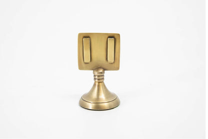 Brass-colored place card holders with a square top, two vertical slots, short neck, round base; available in 2" and 4" sizes.