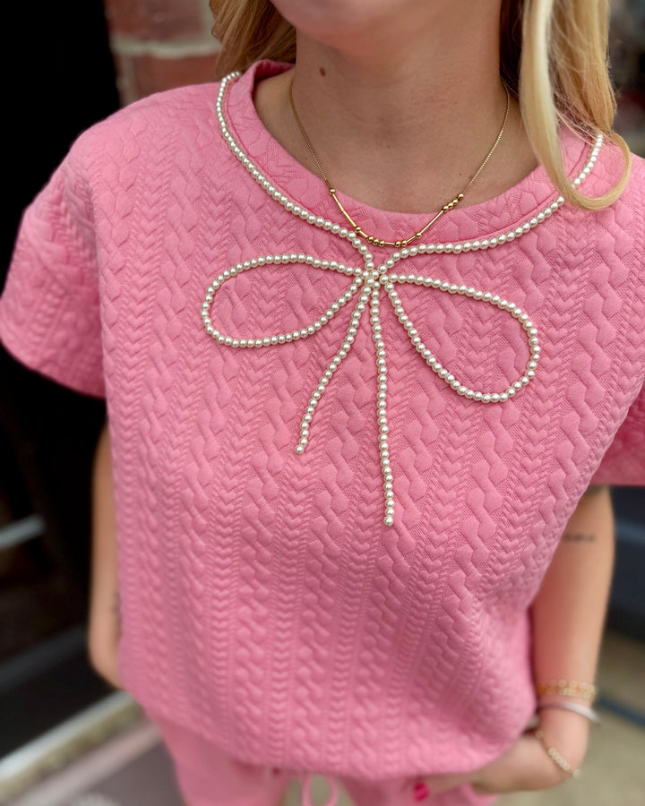 Pearl Pink Ribbon Trim Textured Set with pearl bow detail at neckline; available in sizes XS–XL.