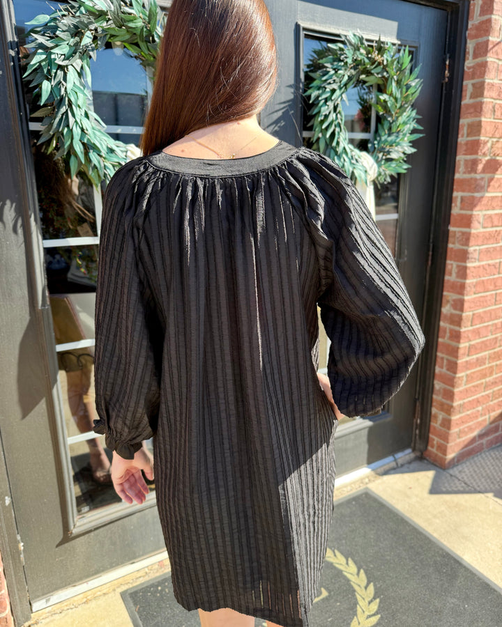 V-Neck Contrast Dress: black cotton shift dress, V-neck, long puffed sleeves, vertical textured stripes. Sizes available.