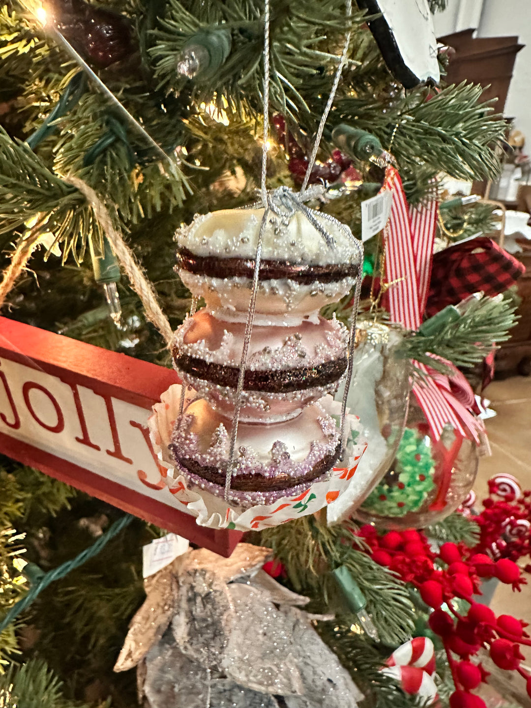 Glitter and silver bead-decorated glass macaron ornament.