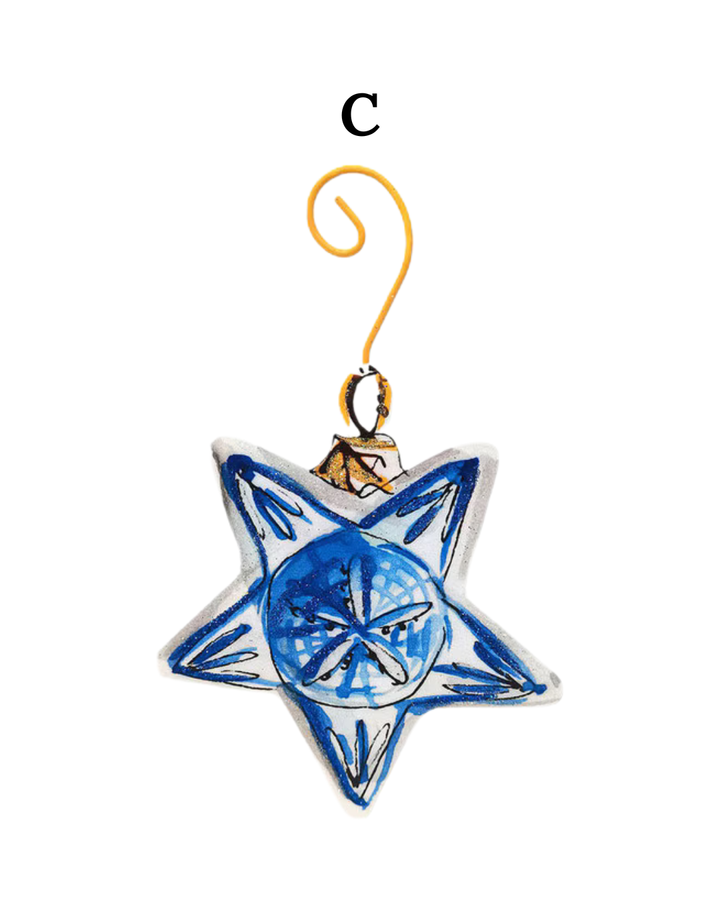 Beck’s Chinoiserie star-shaped ornament with blue and white details, the letter C, and a gold wire hanger.