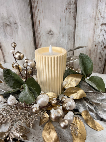 The Glitz And Glamour Candle Ring 4.5in includes a ribbed cream-colored candle with faux greenery, white berries, and gold-silver leaves. Available in 4.5-inch size.