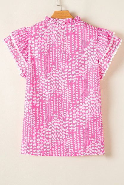 Pink blouse with abstract print, ric rac trim, notch V-neck, pompom-trimmed flutter sleeves. Available in sizes XS-XL.