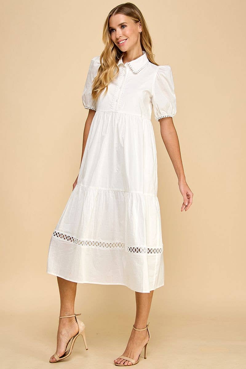 White button-up collared midi dress, contrast trim, short sleeves, tiered skirt. Available in sizes XS–XL.
