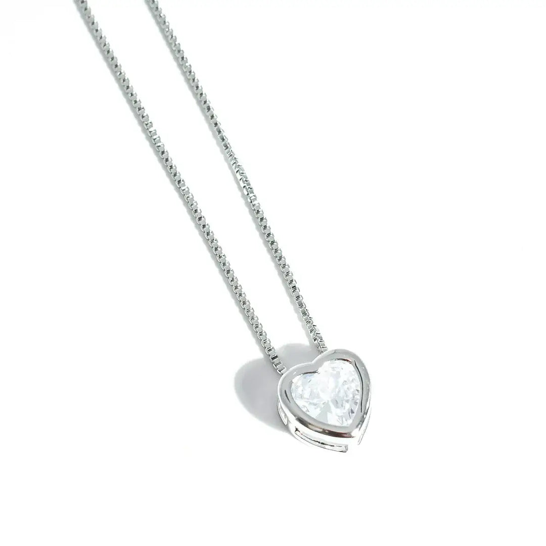 The Tiny Love Necklace: Silver with heart-cut crystal pendant on thin silver chain. Available sizes: 16", 18", 20".