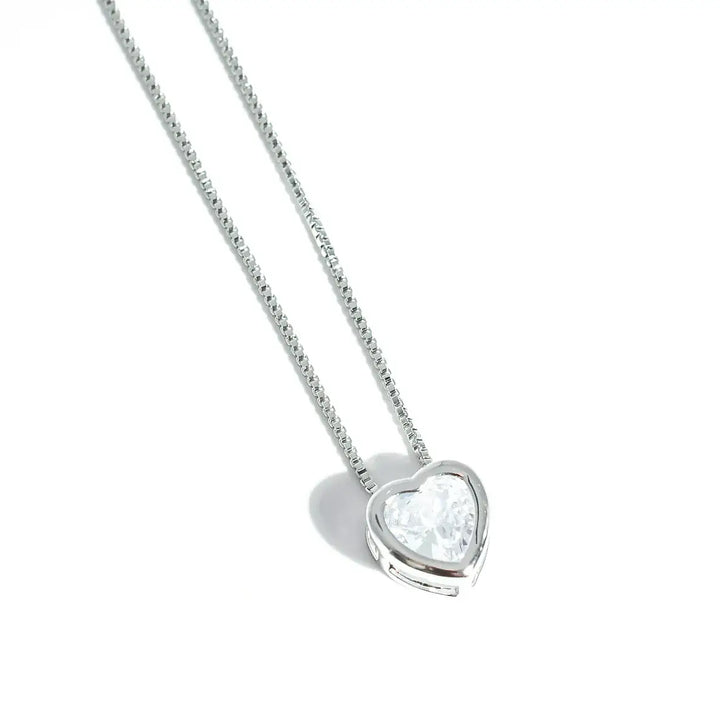 The Tiny Love Necklace: Silver with heart-cut crystal pendant on thin silver chain. Available sizes: 16", 18", 20".