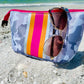 The Olivia Small Neoprene Makeup Bag features a camouflage pattern, pink-orange-yellow stripes, zipper closure; available in small.