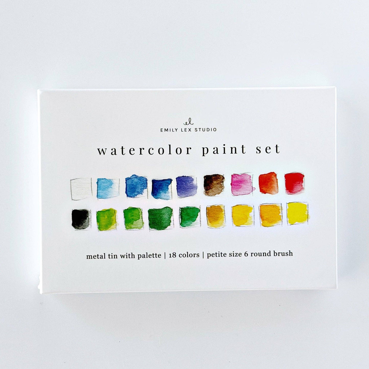 White box labeled “Watercolor paint set 18 colors with brush,” includes 18 vibrant paints, metal tin, mixing palette, and size 6 round brush. Ideal for travel.