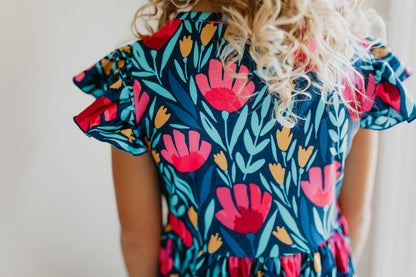 Kids Blue Floral Flutter Sleeve Dress with colorful floral pattern. Available in sizes 2T-6X.