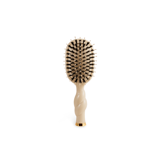 Compact beige Mini Boar Brush | Tan with black and white-tipped bristles, twisted handle. Available in a travel size.