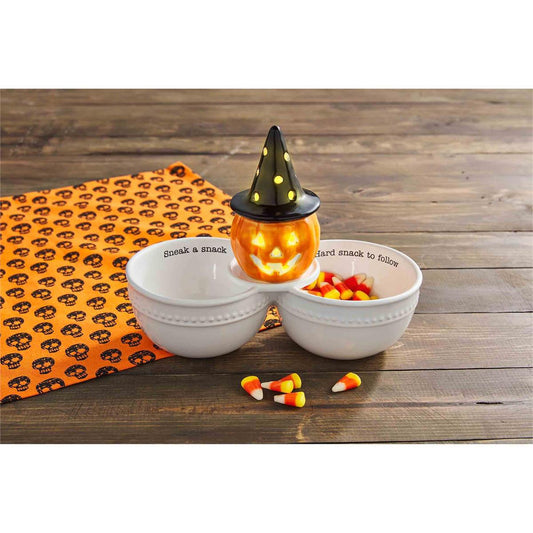 The Light-Up Witch Jack-O-Lantern Sitter is a Halloween decoration that features a charming witch design and emits a warm glow when lit. Sizes available: One size.