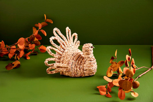 The Hyacinth Turkey Sitter, crafted from woven natural fibers. Sizes available: Medium, Large.