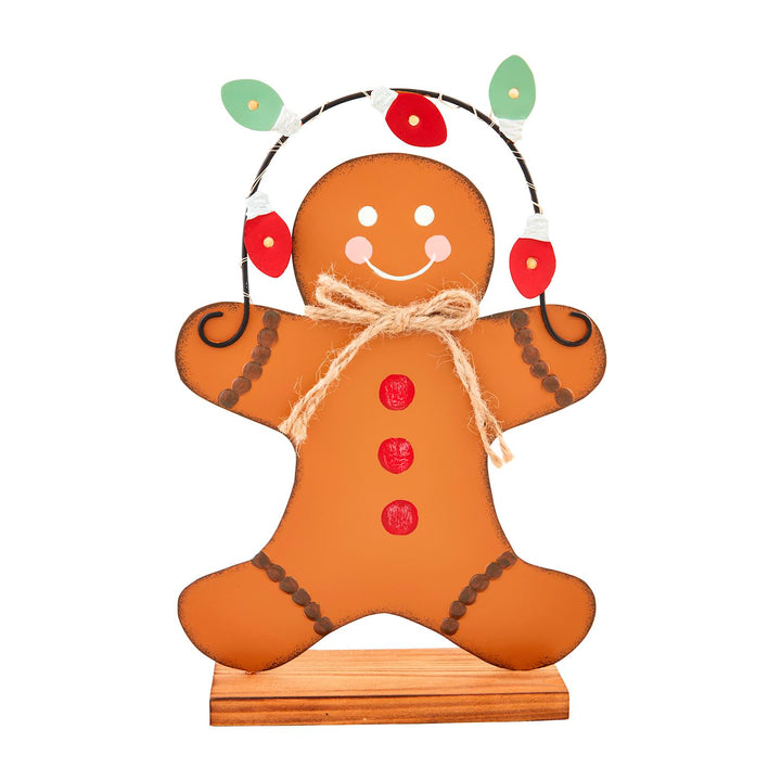Tin Gingerbread Sitter figurine with decorative holiday lights, twine bow, and wooden base.