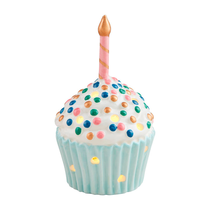 The Cupcake Light-Up Sitter is a decorative piece featuring a cupcake with white icing, colorful sprinkles, and a pink candle in a light blue wrapper. Available in one size.