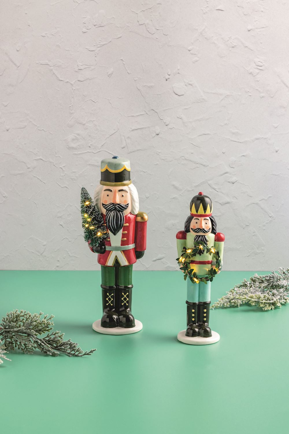 Two Ceramic LED Nutcracker Sitters, illuminated with integrated LED lights.