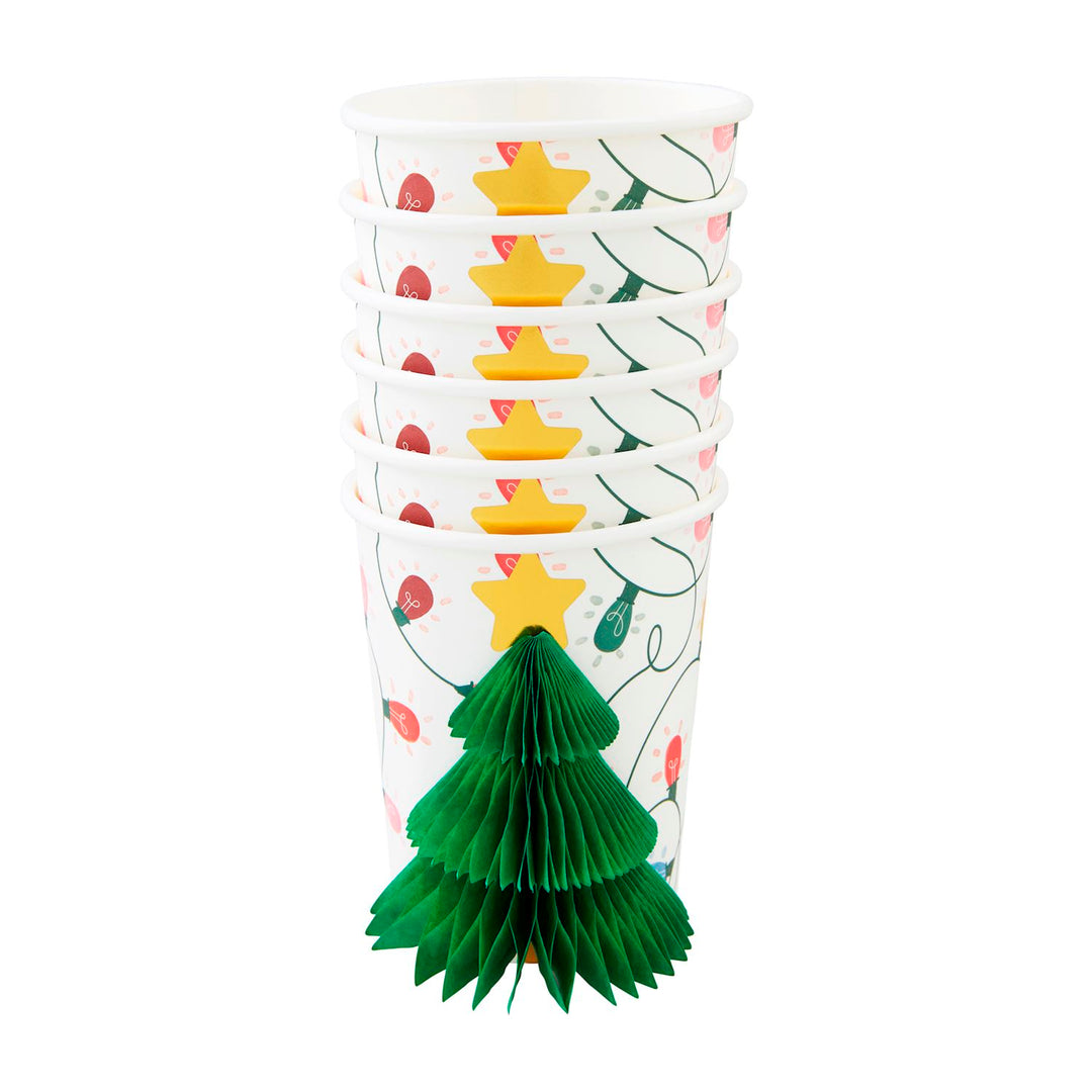Stack of Christmas paper cups with a light and star pattern and a green honeycomb tissue paper tree. Available in multiple sizes.
