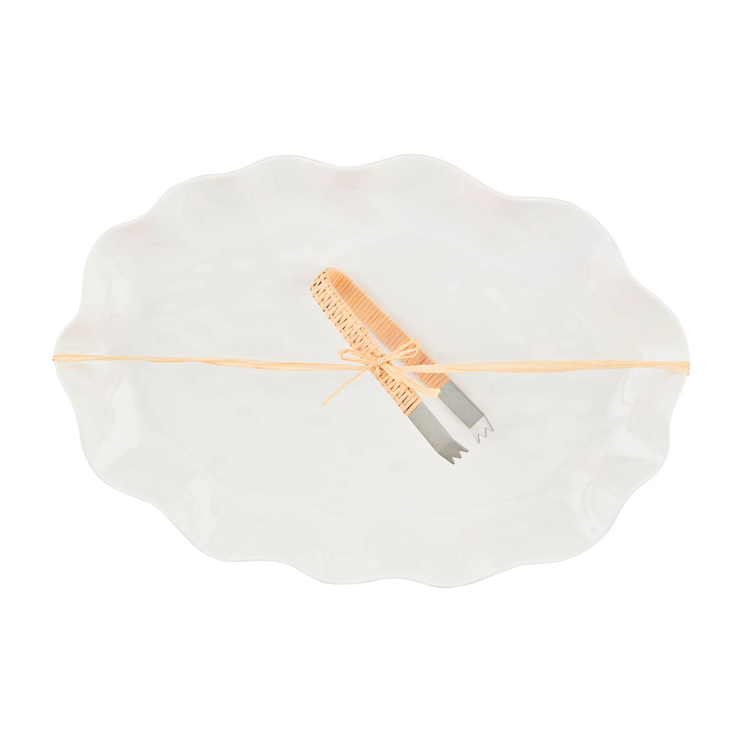 Sizes available: One size. Concise description: White melamine platter with ruffled edge, includes metal tongs with woven beige handles, tied with a beige ribbon.