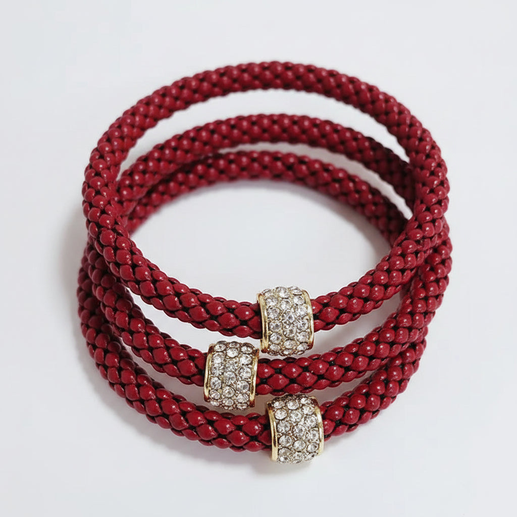 Three red braided bracelets with gold and diamond-encrusted clasps. Available sizes: small, medium, large.