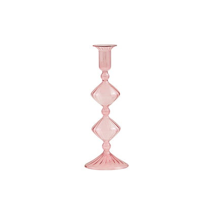 Hand-blown pink Glass Taper Holder with a tall, slim design, features diamond-shaped stem accents and a round, fluted base and top. Sizes available: 10-inch and 12-inch heights.