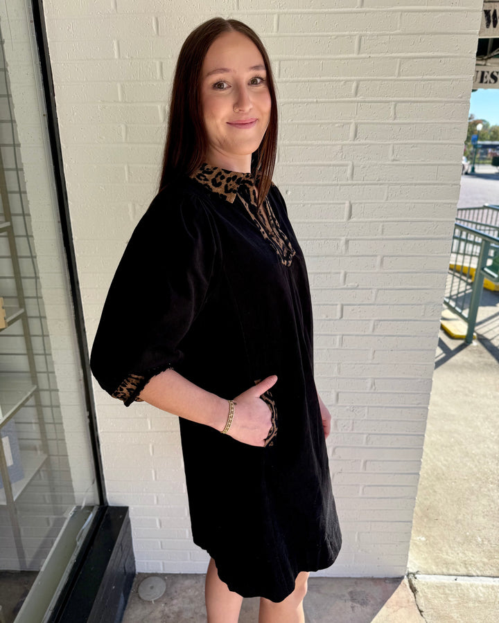 V-Neck Contrast Dress: black shift dress with leopard-print trim on V-neck and cuffs. Sizes available.