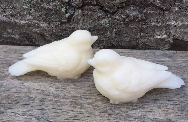 Two white, bird-shaped Sweet Birdy Guest Soaps: Secret Garden, made with shea butter. Available in guest soap size only.
