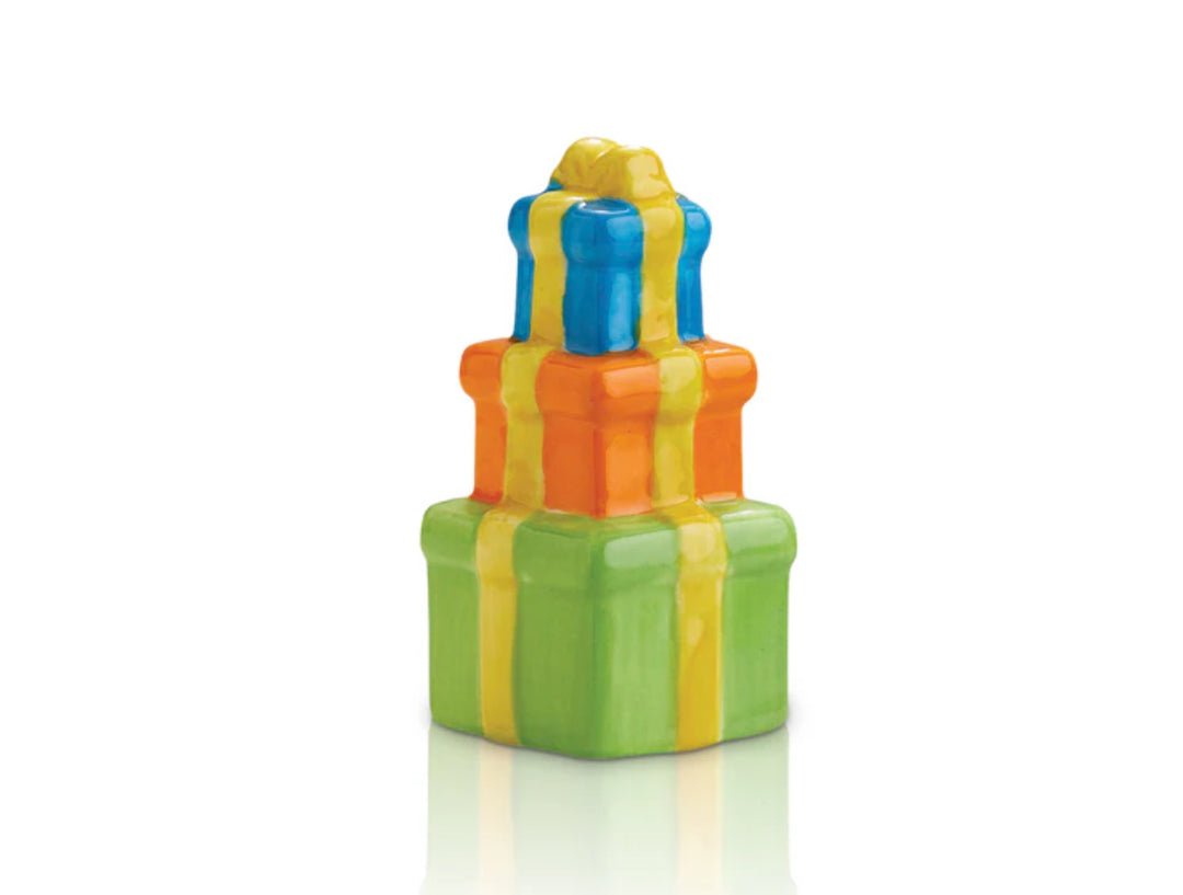 Nora Fleming Minis gift boxes with shiny yellow ribbons; sizes in decreasing order. Bottom box: green, middle box: orange, top box: blue.