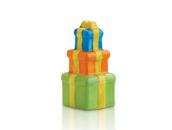 Nora Fleming Minis gift boxes with shiny yellow ribbons; sizes in decreasing order. Bottom box: green, middle box: orange, top box: blue.