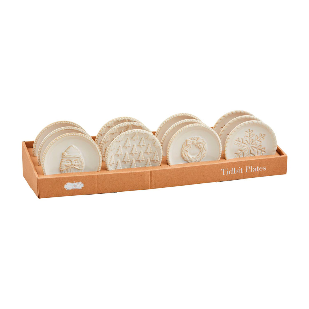 Set of four round milk-glazed stoneware White Christmas Tidbit Plates with embossed Christmas designs.