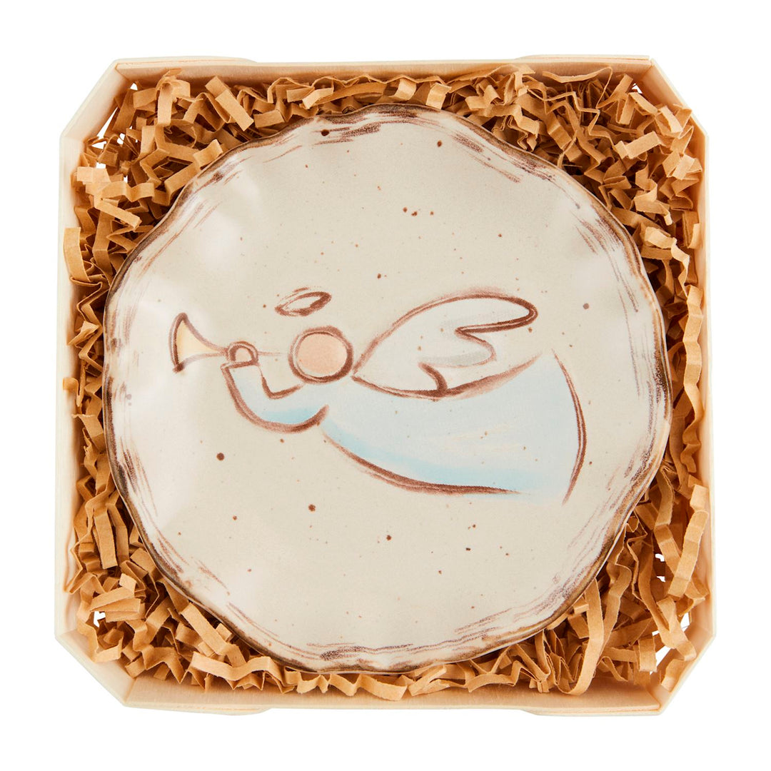Small round Nativity trinket dish featuring an illustrated angel playing a trumpet.