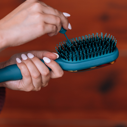 Boar Bristle Hair Brush - Teal With It shown in use. Available in small, medium, and large sizes. Helps maintain frizz control and ensures a glossy finish.