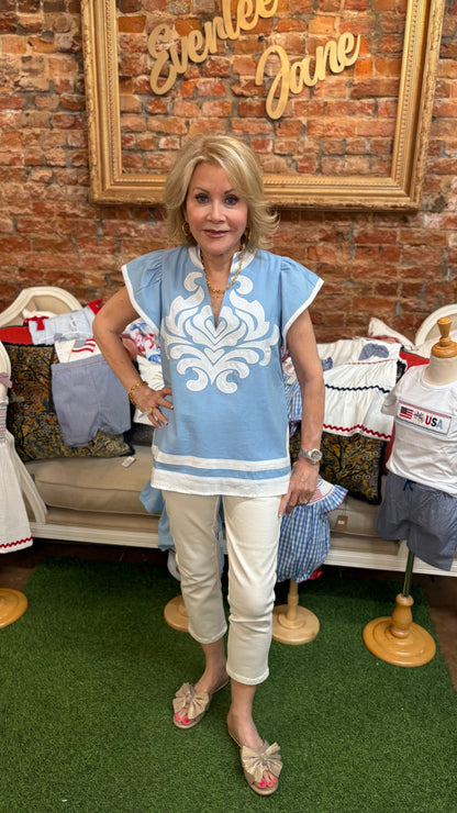 Light Blue Embroidered Appliqué Design Top, available in sizes S-XL. Features intricate appliqué and short sleeves.