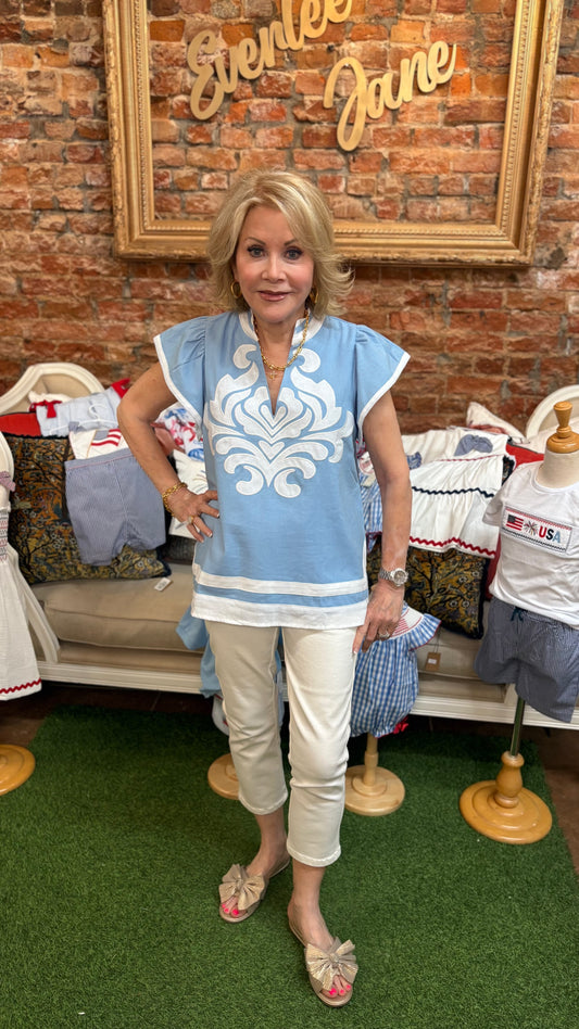 Light Blue Embroidered Appliqué Design Top, available in sizes S-XL. Features intricate appliqué and short sleeves.