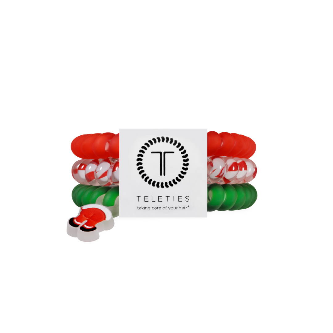 Three Claus I said So hair ties, size small, in red, candy cane swirl, and green, each with a Santa boot charm.