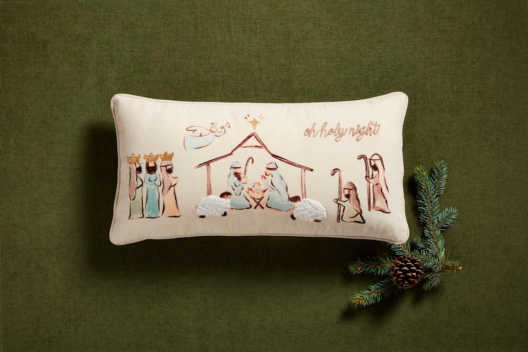 Rectangular nativity pillow with embroidered “oh holy night” scene.