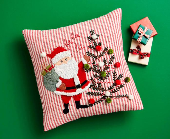 Fa La La Santa Pillow, a square cotton cushion with a red and white striped cover, embroidered Santa with a sack and Christmas tree, and “fa la la” text.