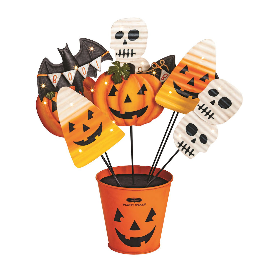 Halloween Light-Up Plant Stakes set with an orange jack-o’-lantern bucket and assorted stakes shaped like pumpkins, ghosts, skulls, and a bat with a “BOO” banner. Sizes available.