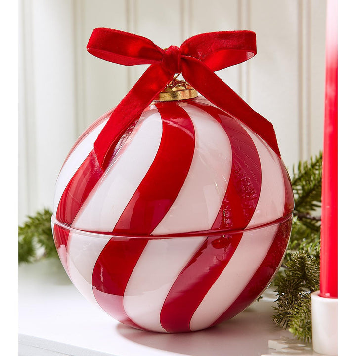 Sugar Cookie Ornament Candle, round lidded design with red and white stripes and a red velvet bow.